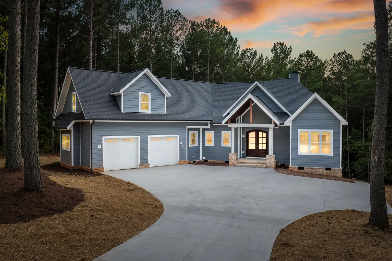 New architectural shingle roof at twilight on a craftsman home in Hickory, NC, installed by S&S Roofing