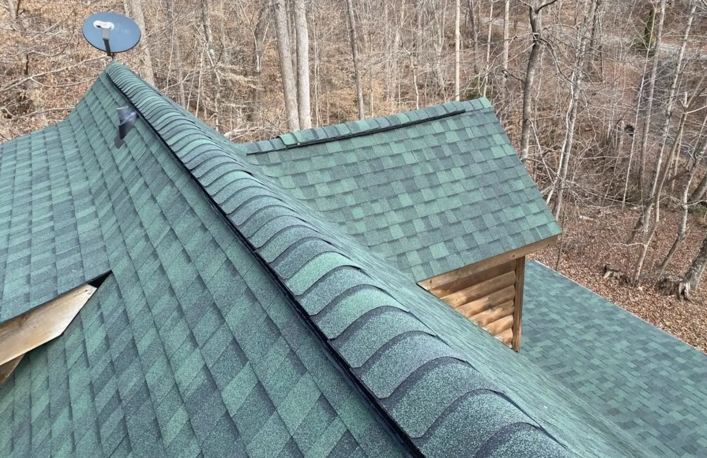 Green roof replacement on a log cabin in the NC Foothills by S&S Roofing